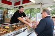 man handing man food