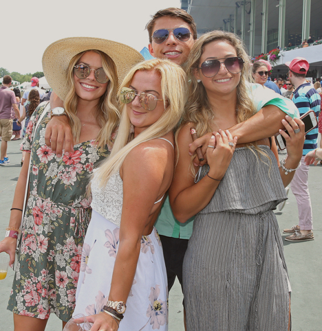 four patrons smiling for camera