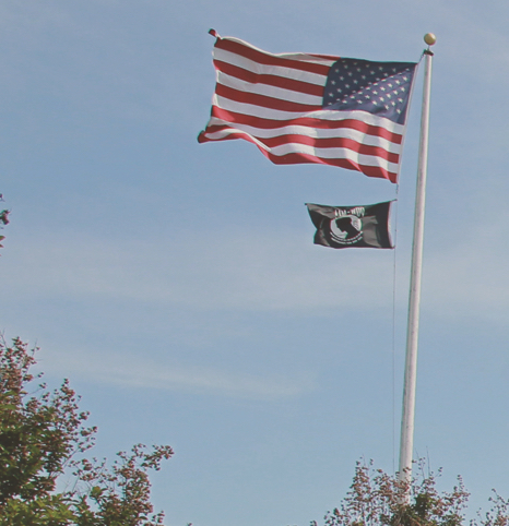 flag pole with US flag and POW MIA flag