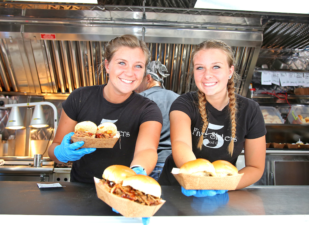 girls holding sandwhiches