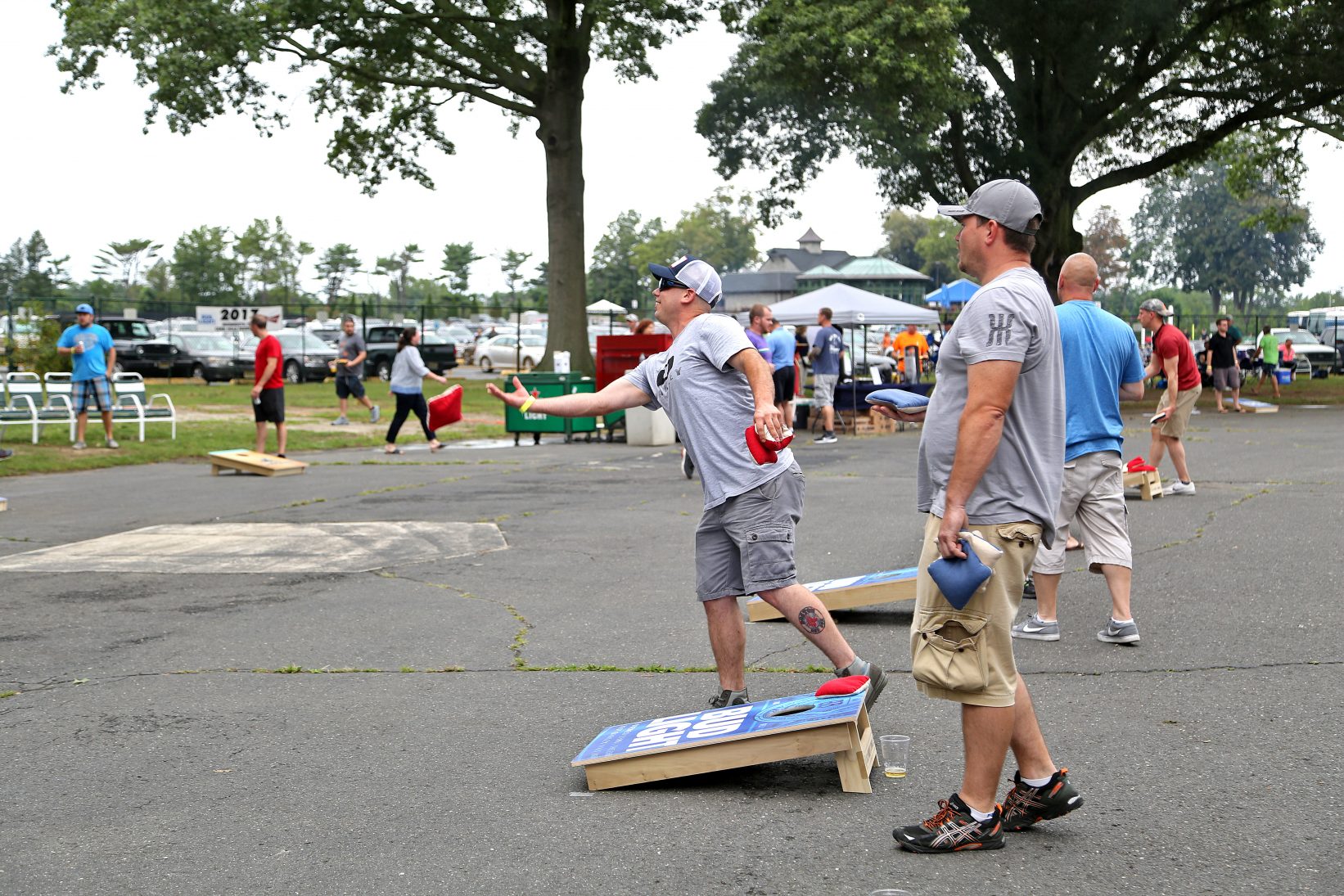 men playing cornhole
